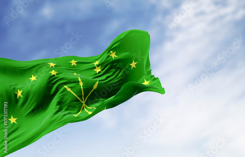 The Circassian flag waving in the wind on a clear day photo