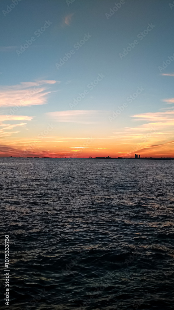A serene ocean view during sunset with vibrant colors and a calm horizon. A serene ocean view during sunset with vibrant colors and a calm horizon.