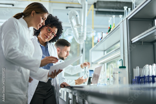 Medical experts talking while working on medical research in laboratory.