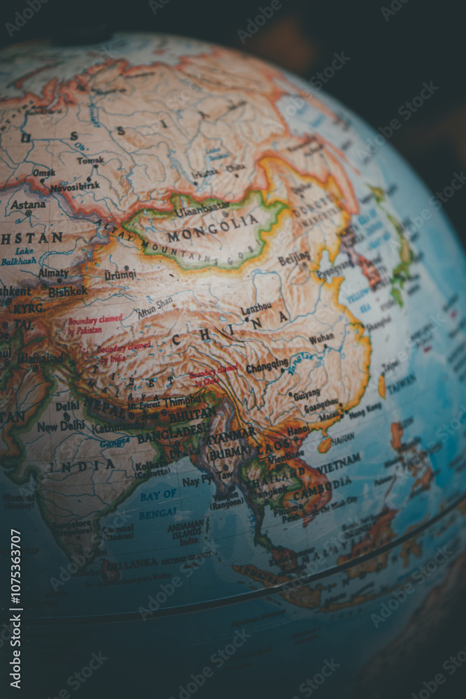 China on the world globe - a close up shot of the country of China and the continent of Asia as seen on a vintage globe \ map China on the world globe - a close up shot of the country of China and the continent of Asia as seen on a vintage globe \ map