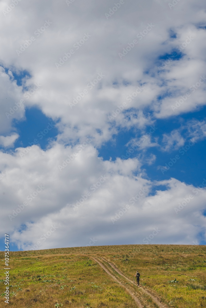 Small Person Walking Up Big Mountain Hill
