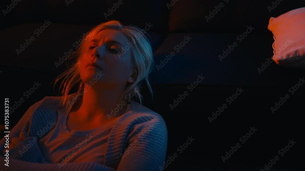 Upset female suffering depression, lying on couch at night, difficult period Upset female suffering depression, lying on couch at night, difficult period