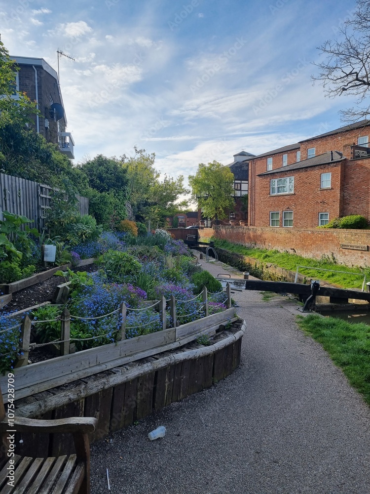 Fototapeta premium Flowerbed by the canal