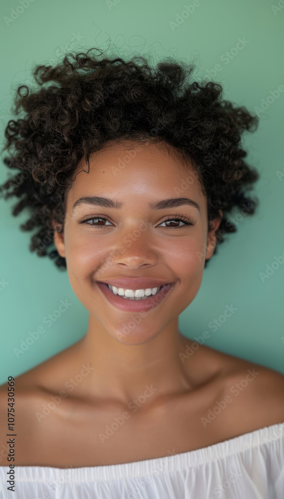 Friendly Portrait of a Curly-Haired Young Woman Against Mint Green Background Friendly Portrait of a Curly-Haired Young Woman Against Mint Green Background