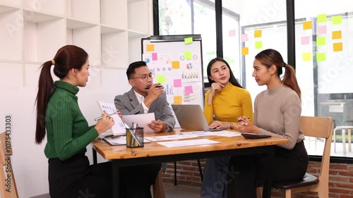 Wallpaper Mural Team of Asian creative business teamwork and startup worker meeting in office. Coworkers young woman team at work, Group of young business working together with analysis report chart in office. Torontodigital.ca
