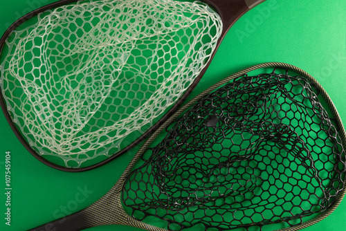 Modern fishing landing net with silicone mesh in black and white.