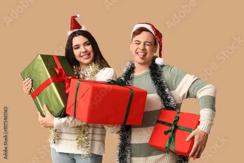 Young couple in Santa hats ...