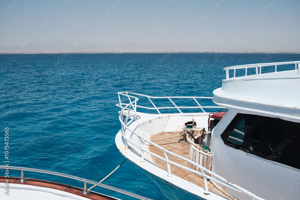 Fototapeta premium Boat deck. Wide angle view of the yacht front opposite blue sea