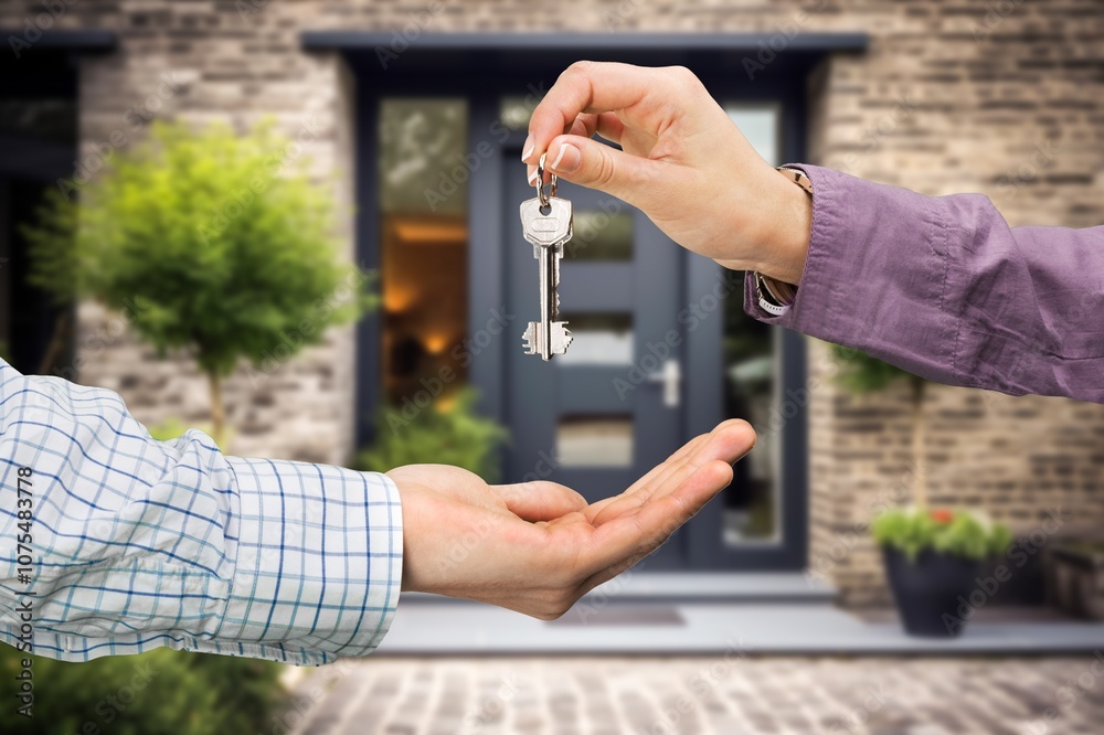 Person buying new home holding key