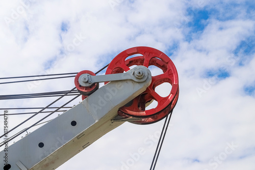 Closeup of the lifting block of the open-mine excavator against a sky