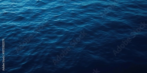 Dark blue abstract surface of the water with subtle rippling and distortion, fluid, wavering photo