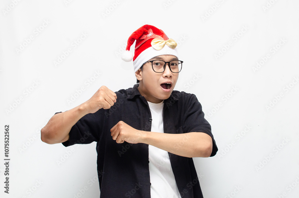 happily attractive young asian man wearing santa claus hat and christmas glasses dancing and celebrating christmas. christmas and holiday concept. happily attractive young asian man wearing santa claus hat and christmas glasses dancing and celebrating christmas. christmas and holiday concept.
