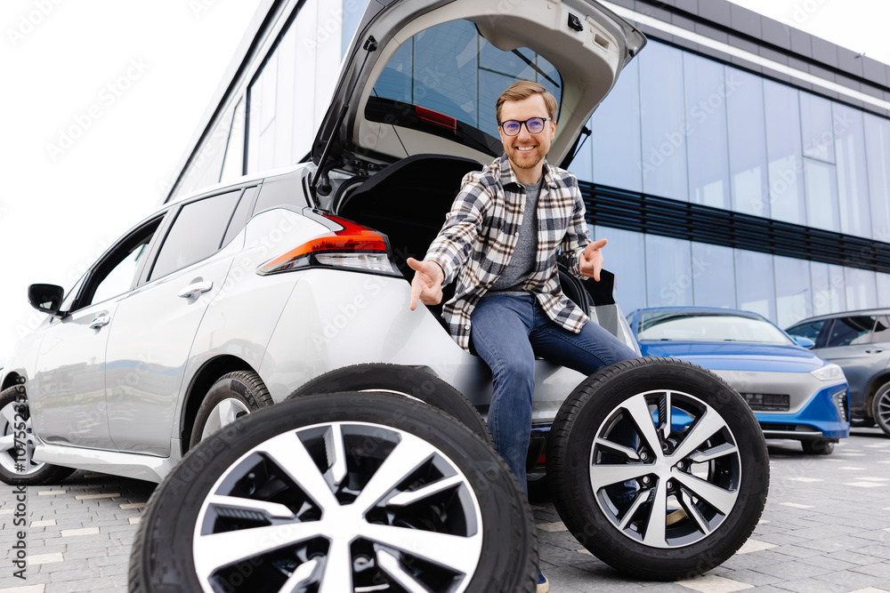 Car mechanic working in car showroom and changing wheel alloy tire. Repair or maintenance auto service. Car mechanic working in car showroom and changing wheel alloy tire. Repair or maintenance auto service.