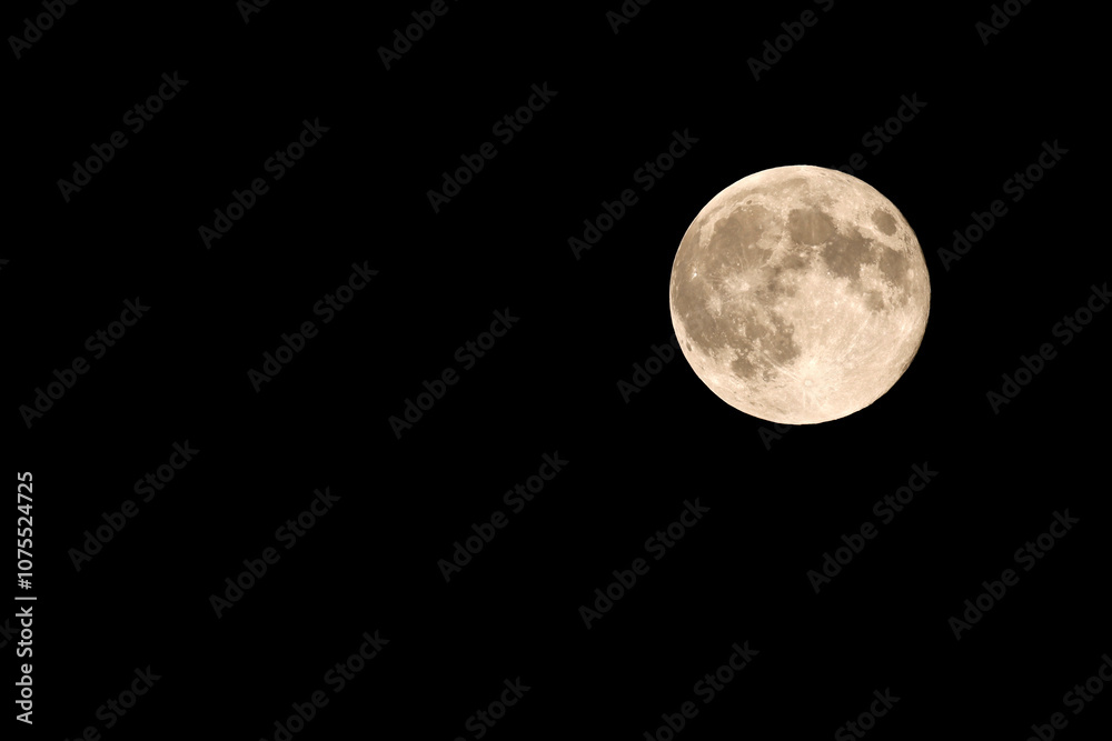 Full moon on night black sky, luna planet isolated in the black dark night with copy space Full moon on night black sky, luna planet isolated in the black dark night with copy space