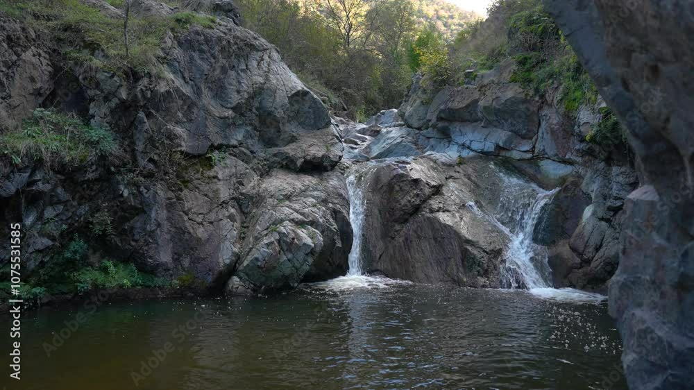 A stunning view of a waterfall cascading down rugged cliffs, showcasing the power and serenity of nature in a breathtaking landscape. A stunning view of a waterfall cascading down rugged cliffs, showcasing the power and serenity of nature in a breathtaking landscape.