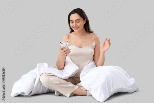 Young woman in pajamas with...