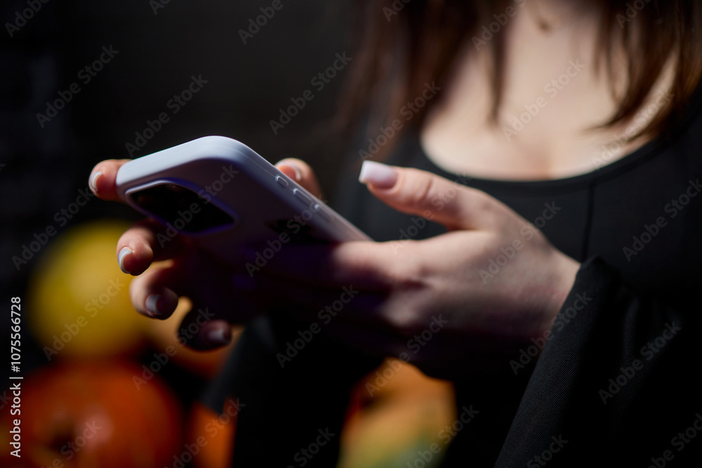 Woman in stylish dress with chic manicure using smartphone in closeup shot Woman in stylish dress with chic manicure using smartphone in closeup shot