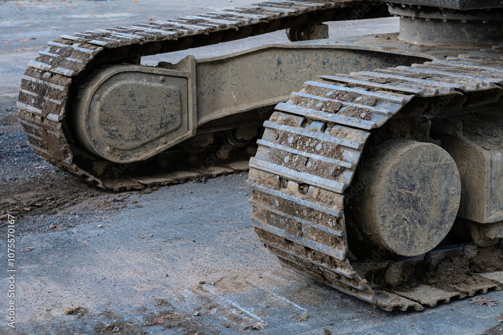 Heavy machinery track resting on a construction site in daylight Heavy machinery track resting on a construction site in daylight
