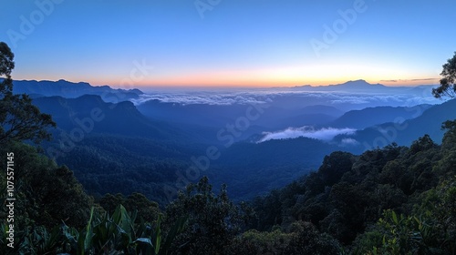 Panoramic view of misty mountain ranges at sunrise.