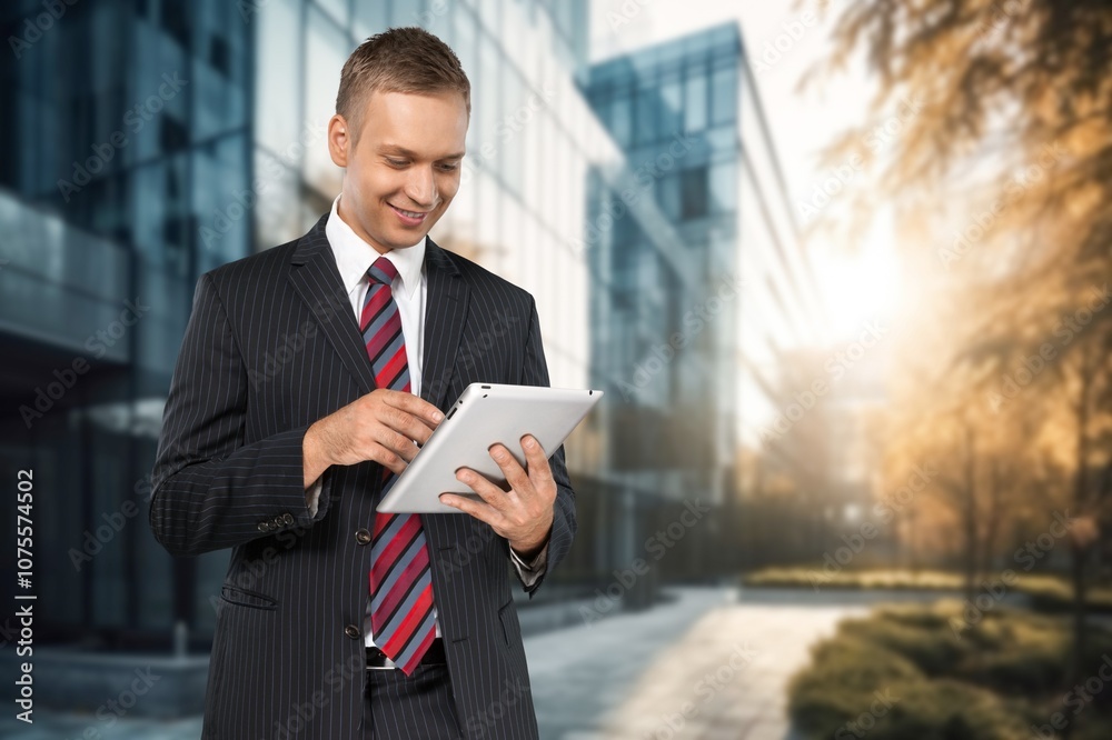 Young businessman posing outdoor at office building. Young businessman posing outdoor at office building.