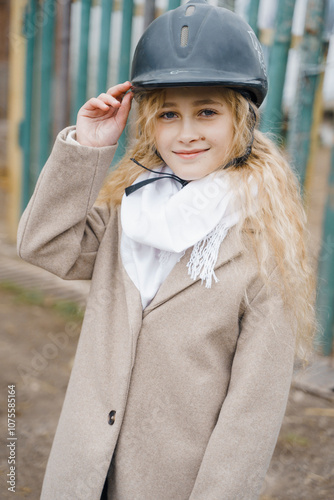 a girl in a helmet for riding horse