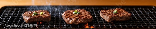 Grilling beef steaks over charcoal with herbs at a backyard barbecue