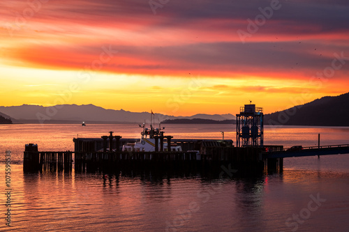 At sunrise a Ferry boat, The "Whatcom Chief" is a 21 car ferry servicing Lummi Island and Gooseberry Point on the mainland. A colorful dawn with impressive clouds is a beautiful way to start the day.