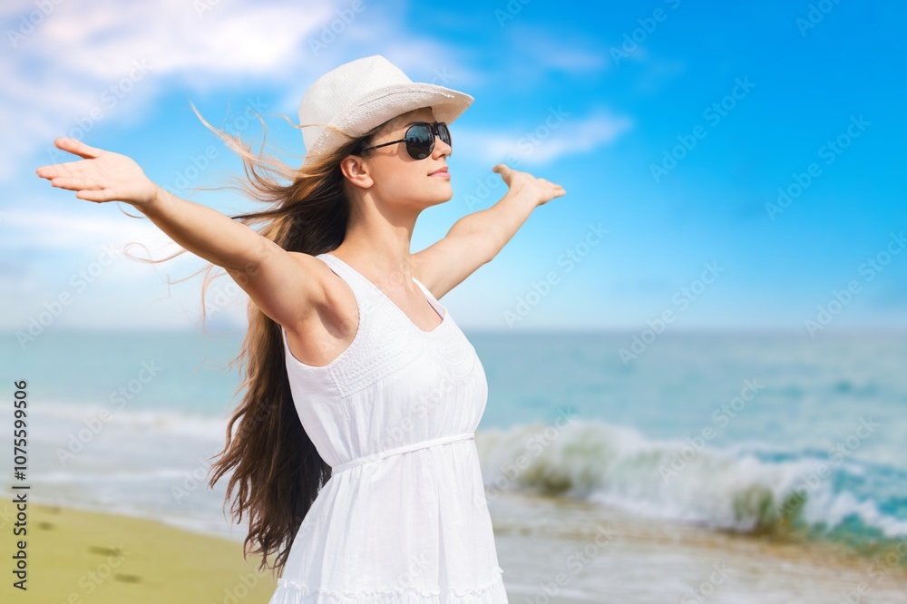 Portrait of beautiful young woman wearing hat at beach Portrait of beautiful young woman wearing hat at beach