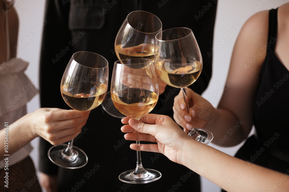 People clinking glasses of wine indoors, closeup People clinking glasses of wine indoors, closeup