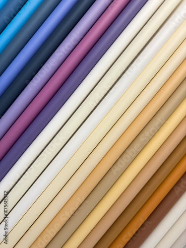 A row of different colored rolls of paper