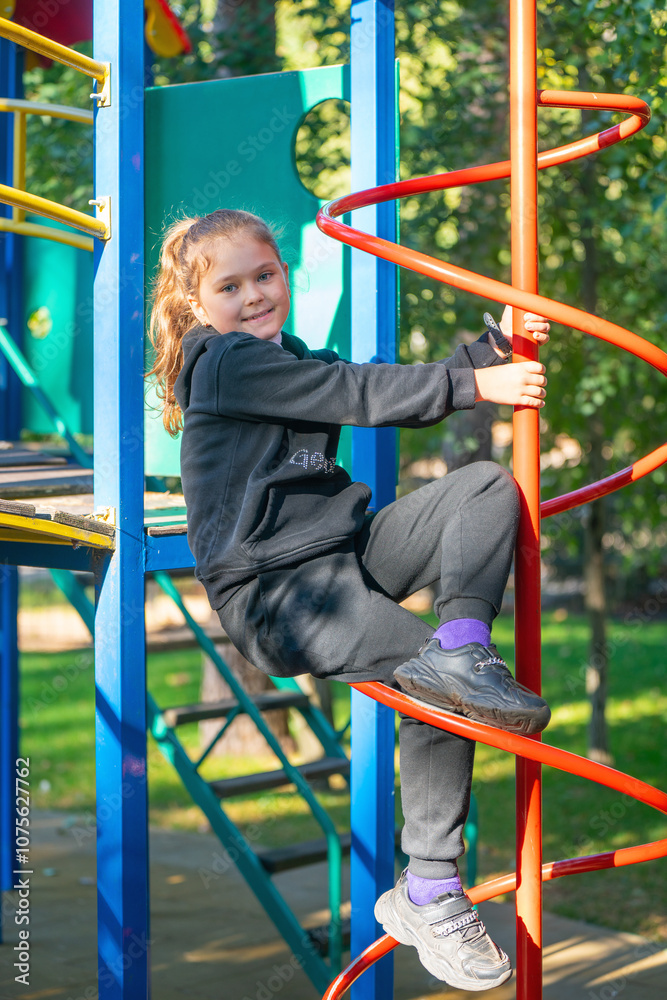 Fototapeta premium Cute beautiful smiling little girl on playground on sunny day