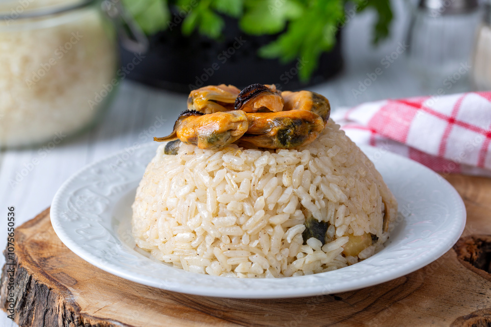 Mussel rice pilaf. Rice with mussels on small white plate on ceramic. (Turkish name; midyeli pilav) Mussel rice pilaf. Rice with mussels on small white plate on ceramic. (Turkish name; midyeli pilav)