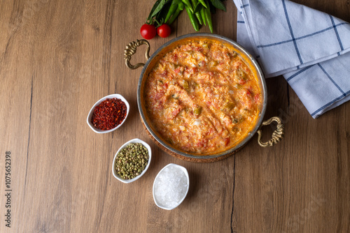 Famous Turkish menemen dinner on table, made by eggs, pepper and tomatoes.