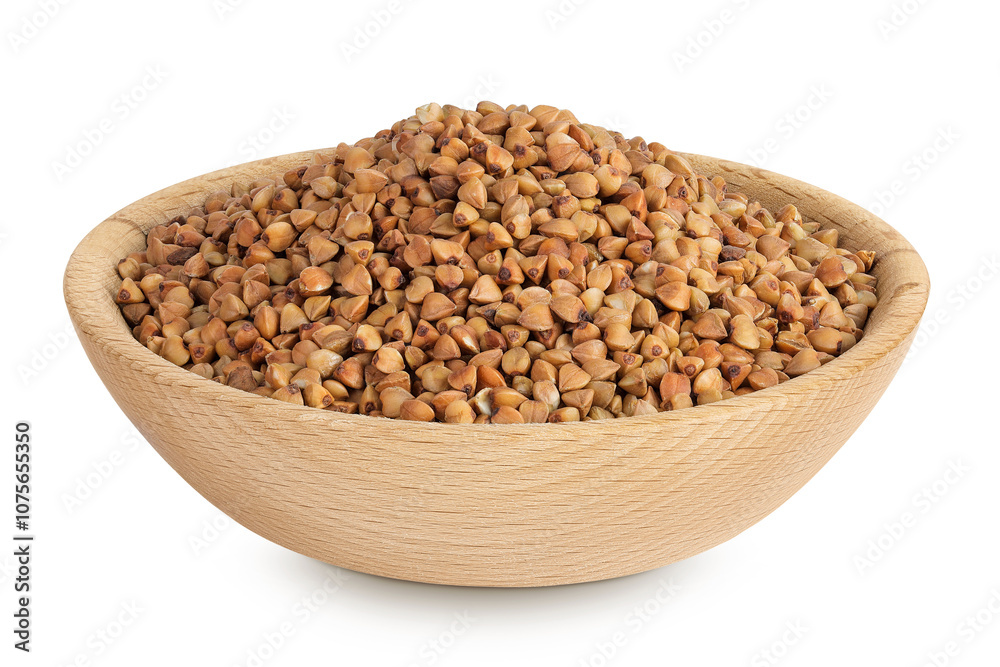 Raw buckwheat in wooden bowl isolated on white background Raw buckwheat in wooden bowl isolated on white background