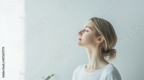 Woman enjoying deep breathing bright room clean background  copy space