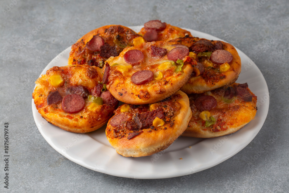 Mini pizza with ham, olives and mozzarella - a delicious snack Mini pizza with ham, olives and mozzarella - a delicious snack