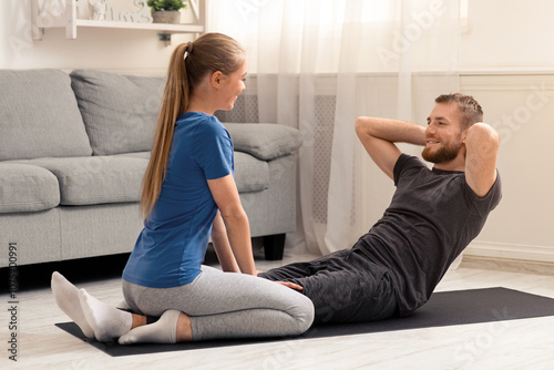 Spoty self-isolation. Young couple training at home on quarantine, free space photo