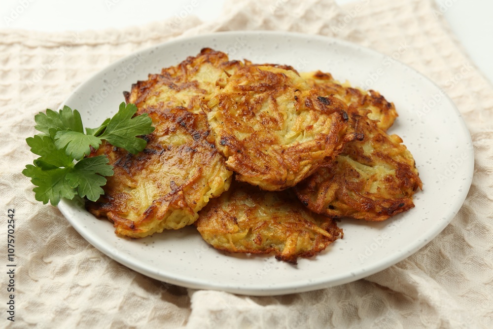 Delicious potato pancakes and parsley on table, closeup Delicious potato pancakes and parsley on table, closeup