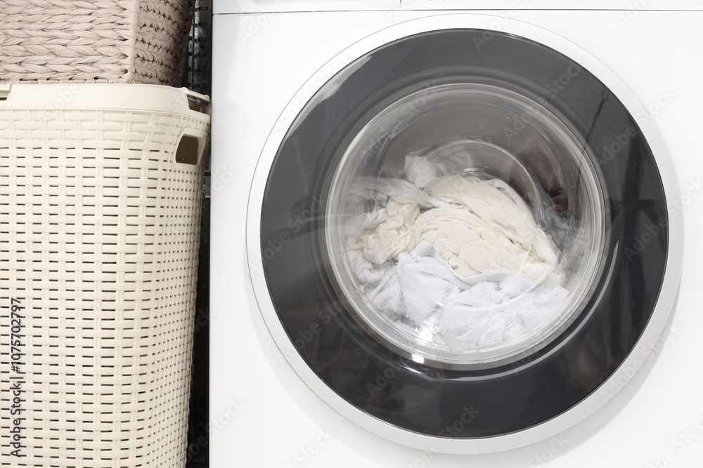 Washing machine with clothes as background, closeup Washing machine with clothes as background, closeup