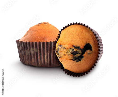 Tasty blueberry muffins in cupcake liners isolated on white