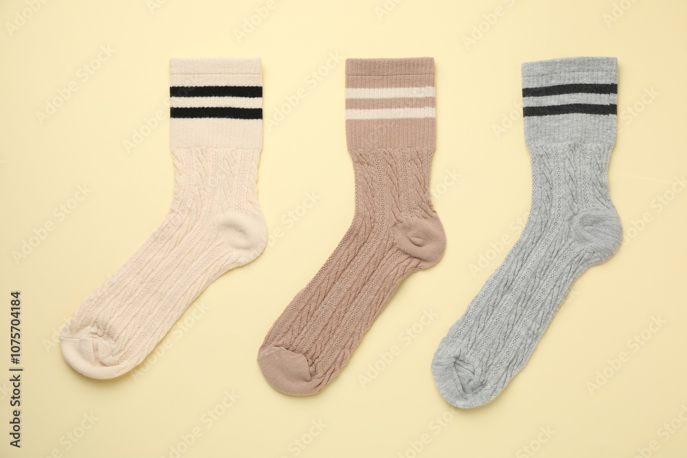 Different comfortable socks on beige background, flat lay Different comfortable socks on beige background, flat lay