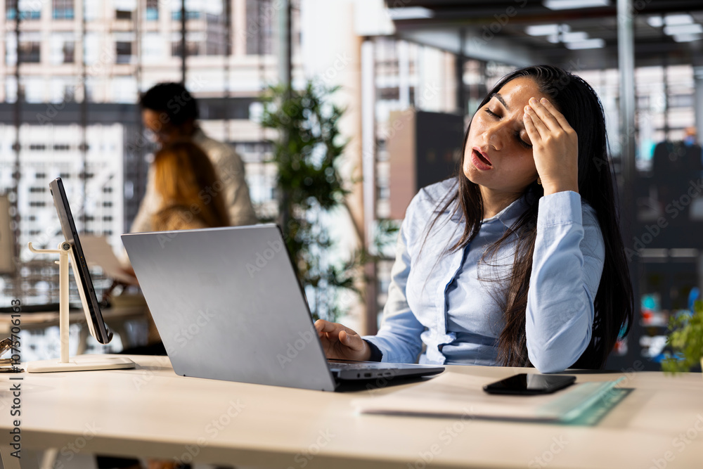 Obraz premium Corporate indian woman experiences business pressure at the office, overwhelmed by administrative tasks and deadlines. Manager with frustration dealing with fatigue and low energy.