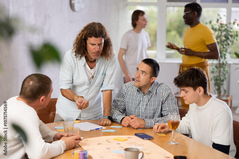 Group of active men play board games during a friendly meeting