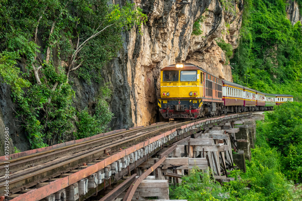 Naklejka premium Trains running on death railways track crossing kwai river in kanchanaburi thailand this railways important destination of world war II history builted by soldier prisoners.