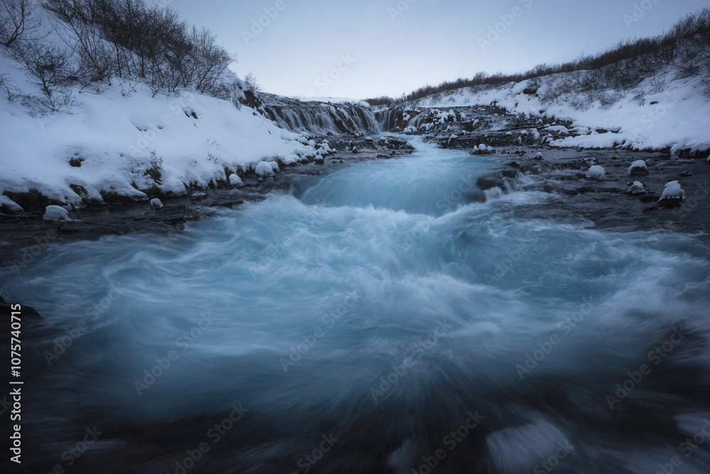 Majestic Icelandic Waterfall Amid Snowy Landscape Majestic Icelandic Waterfall Amid Snowy Landscape