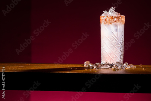 Elegant Paloma Cocktail with Salted Rim and Ice on Table photo