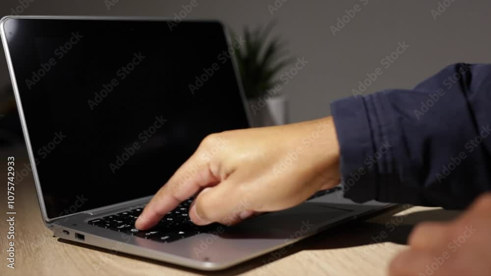 Businessman engaged in typing on a laptop keyboard while utilizing the trackpad Businessman engaged in typing on a laptop keyboard while utilizing the trackpad