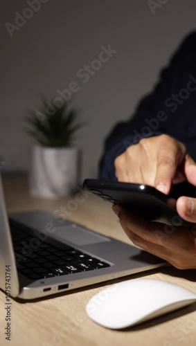 Businessman authentically using smartphone at desk