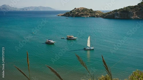 boats and catamaran anchored at sea photo