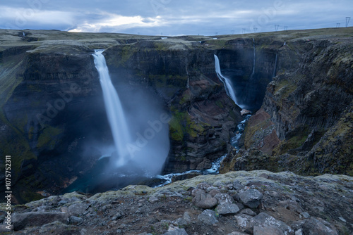 Large Waterfall in Iceland coming from cliffs, moody, foggy